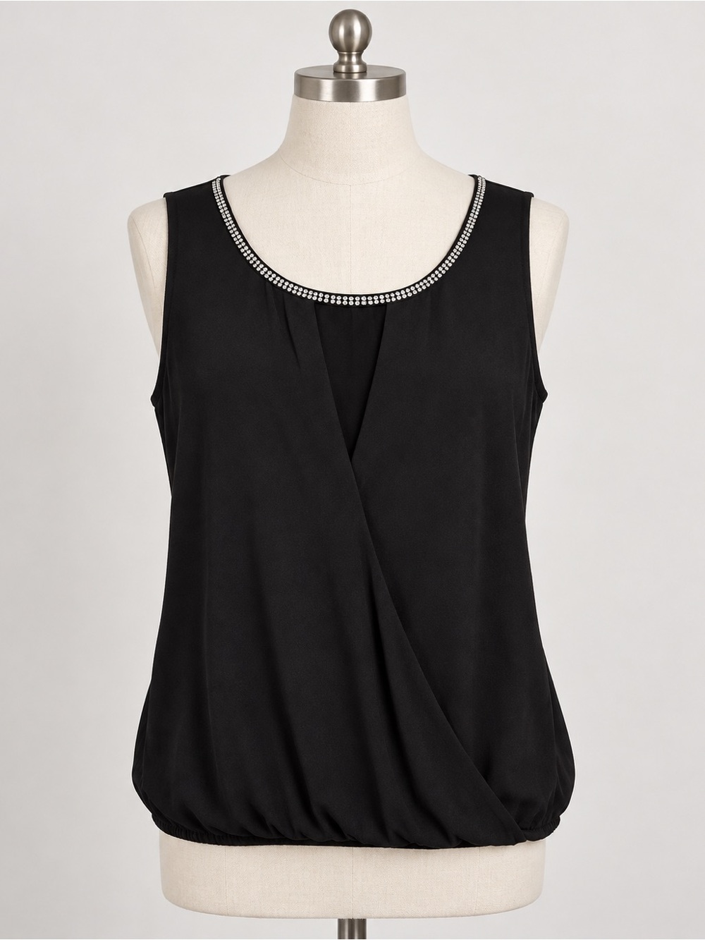 Jennifer Lopez black sleeveless blouse